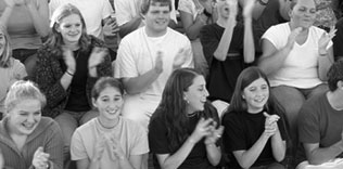 Spectators clapping and cheering.